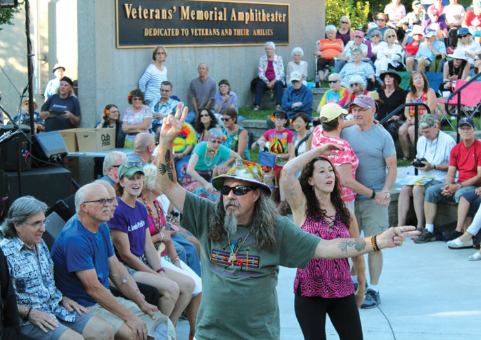  An attendee of the Summer of Love concert flashes peace signs after he joined other veterans recognized July 29 at Veterans’ Memorial Amphitheater in St. Louis Park. (Sun Sailor staff photo by Seth Rowe) 