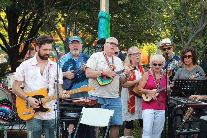  The Twin Cities Ukulele Club performs “Blowin’ in the Wind” July 29 in Wolfe Park. (Sun Sailor staff photo by Seth Rowe) 