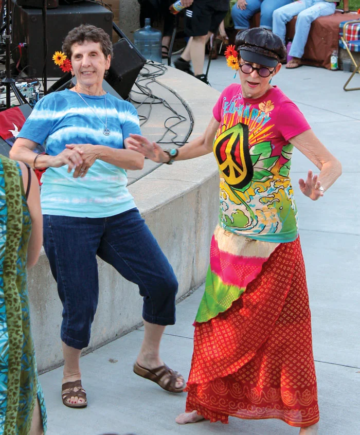 Summer of Love concert attendees dance beside the stage at Veterans’ Memorial Amphitheater. (Sun Sailor staff photo by Seth Rowe)