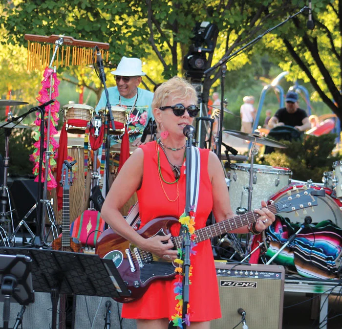 Barbara Meyer plays the guitar and sings at the Summer of Love concert. (Sun Sailor staff photo by Seth Rowe)