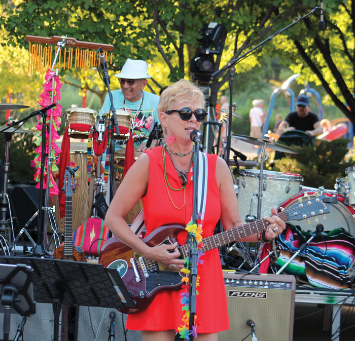  Barbara Meyer plays the guitar and sings at the Summer of Love concert. (Sun Sailor staff photo by Seth Rowe) 