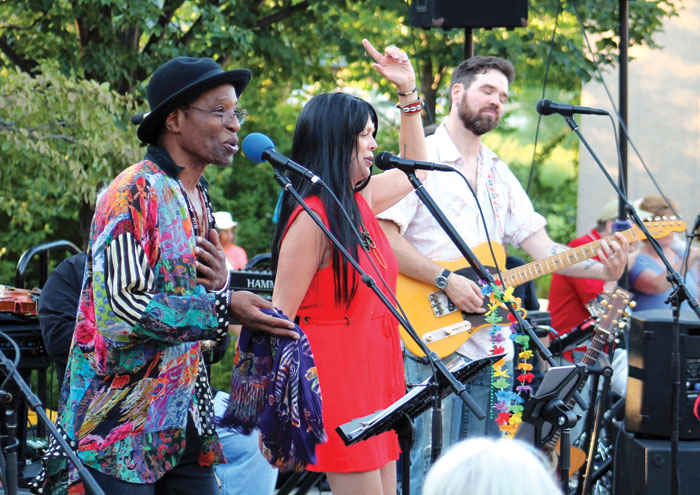 Stanley Kipper, left, and Barbara Meyer, center, channeled Sonny & Cher while singing “The Beat Goes On” during the Summer of Love concert. (Sun Sailor staff photo by Seth Rowe)