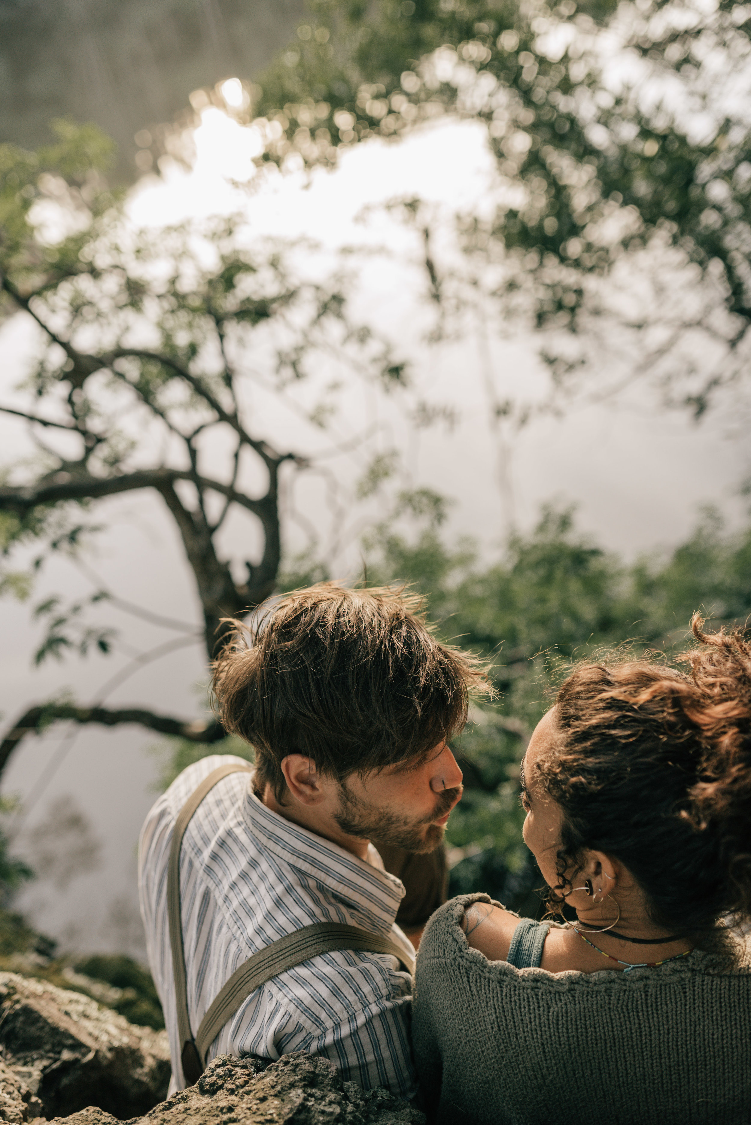 couple sitting on rocks next to lake anza