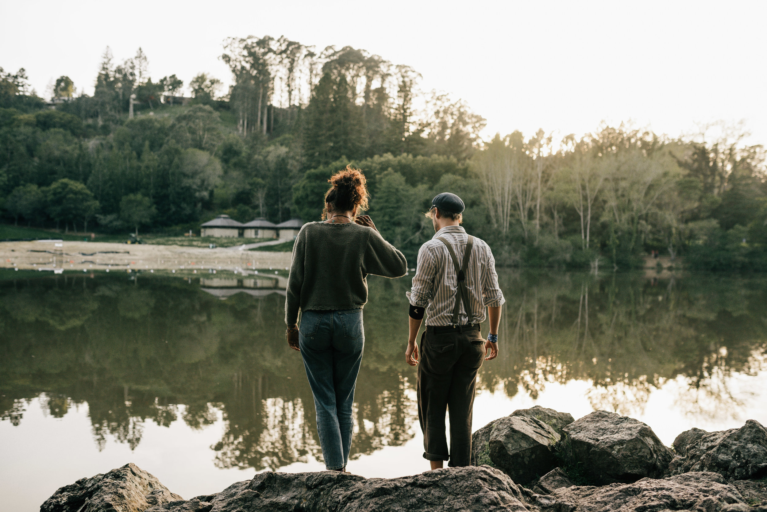 couple standing next to lake anza at sunset