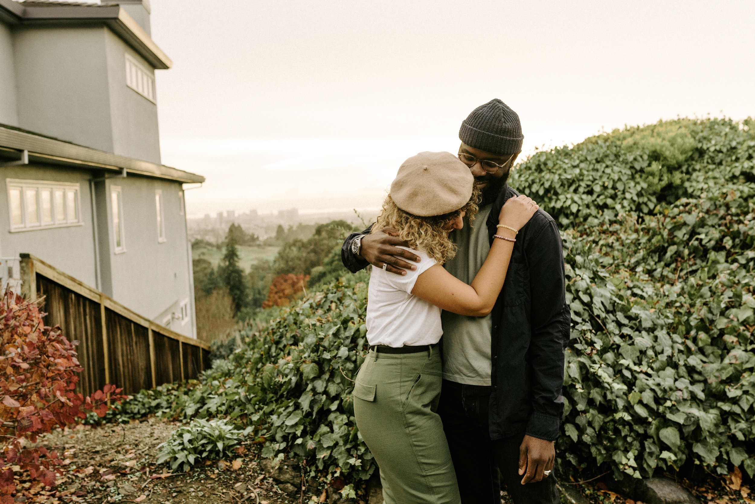 couple hugging each other in front of a house