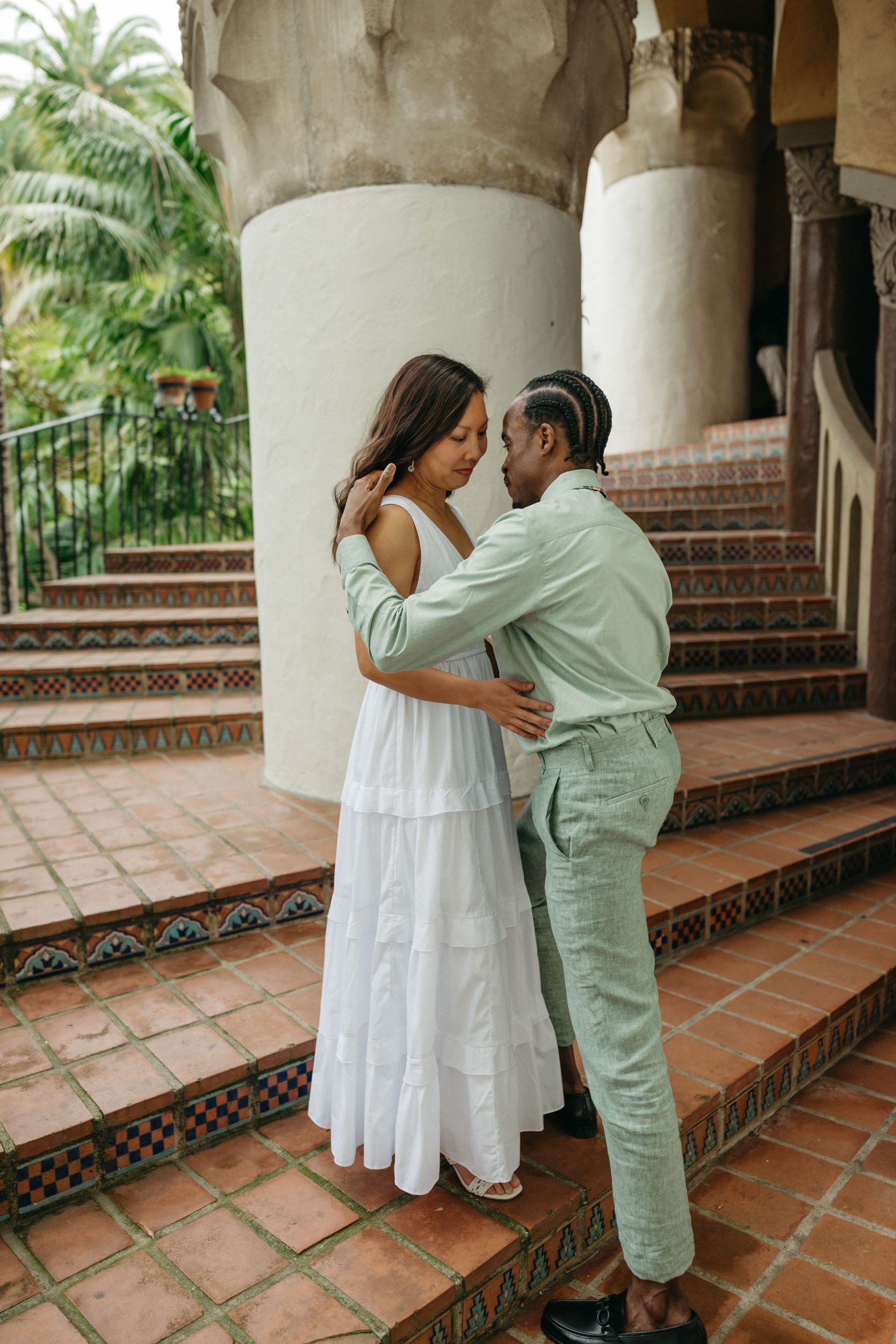 Young couple poses for a photograph at their Santa Barbara Courthouse Wedding, photographed by Amira Maxwell