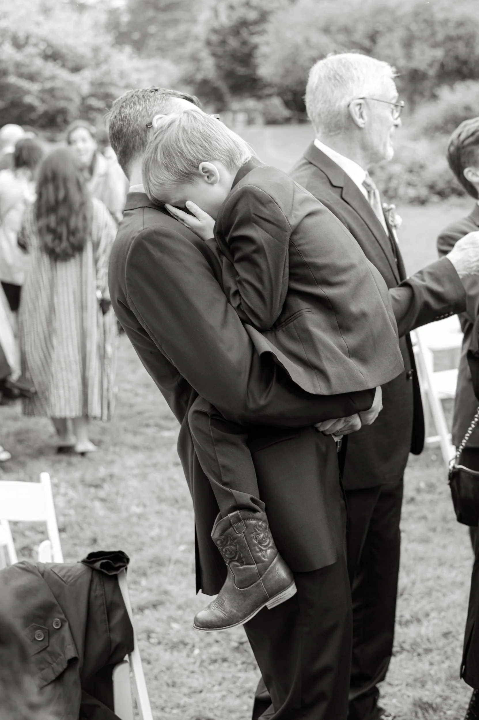 A stylish kid photographed in cowboy boots at a Northern California wedding.