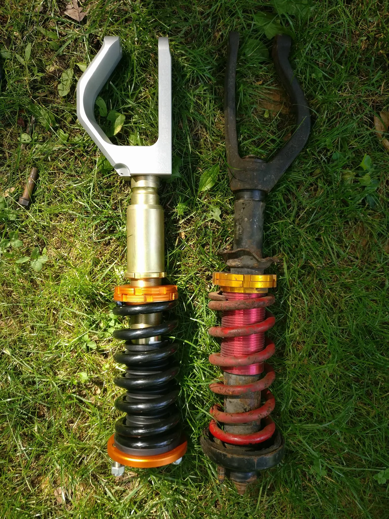 Here is the old setup alongside the new setup. The new fork hadn't been fully mounted yet (thus the obvious gap at the bottom of the coil) but you can also clearly see the height difference in the forks. The drop resulted in dropping the car about 2 additional inches.