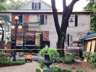All of the brick is now off of the Front Street facade of the Kaminski House. The diagonal wooden boards cover an area that was once open porches. Black tar paper is being installed in these areas to protect the house from the elements.