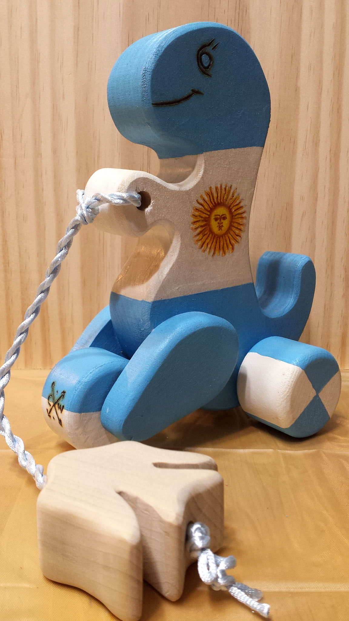 Dino pull toy hand painted with the Argentine flag