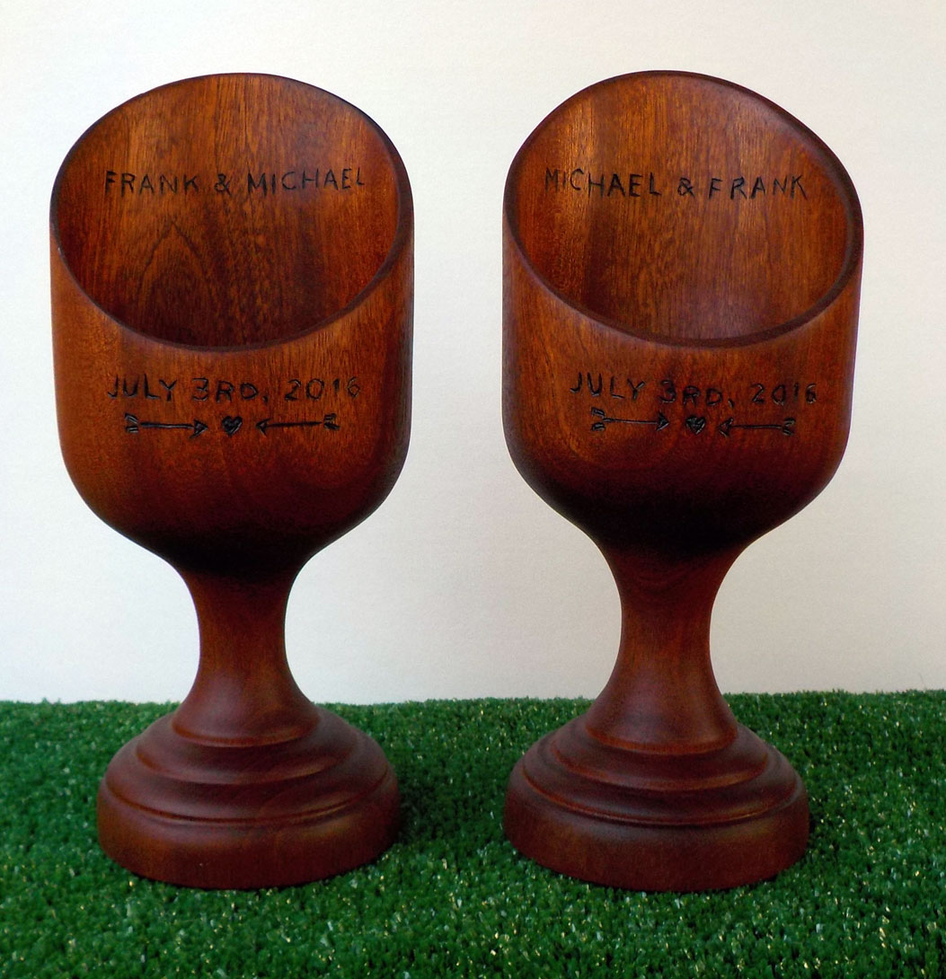 Matching mahogany wedding present vessels inscribed with names and dates to commemorate the special day.