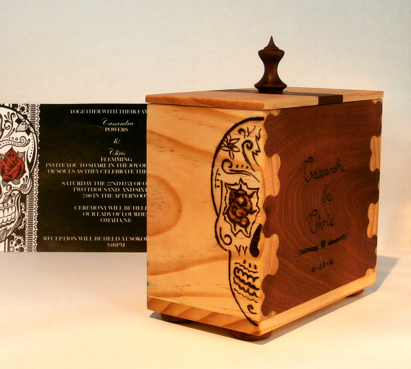 Mahogany and pine box with heart shaped dovetail joints. Wood burnt inscription and Dia de Los Muertos skull decoration to match wedding invitation.
