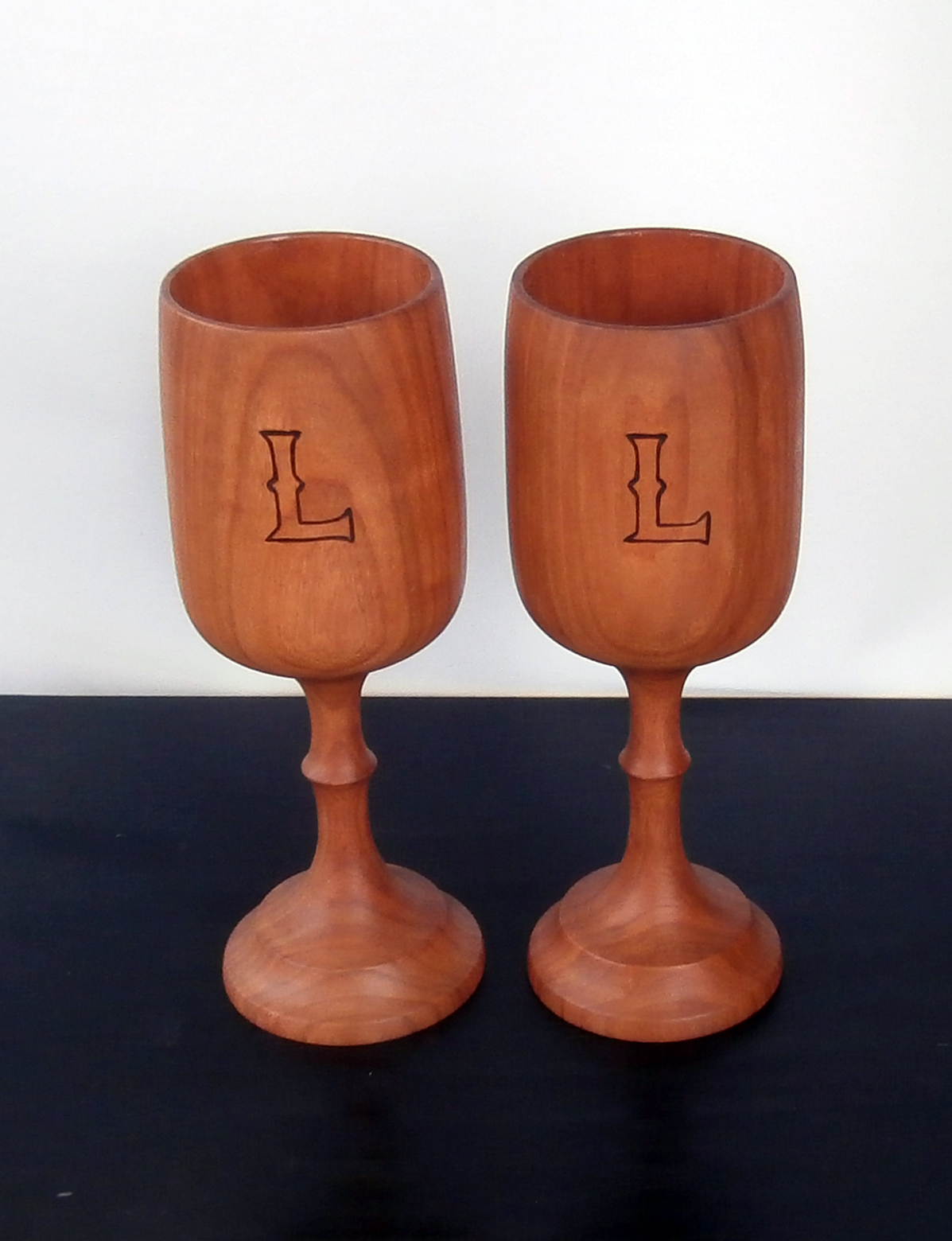 Commissioned set of wine glasses made of Cherry and wood burnt insignia. The inside is coated with food grade epoxy.