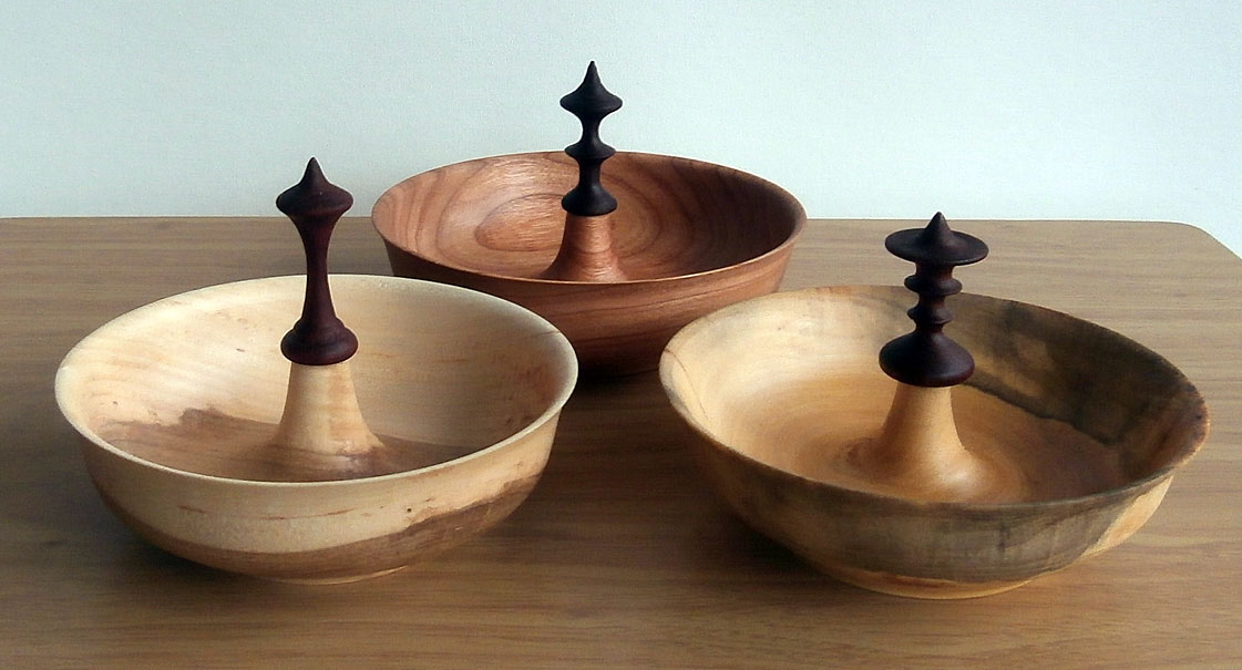 Three unique bowls with decorative finial in the center.