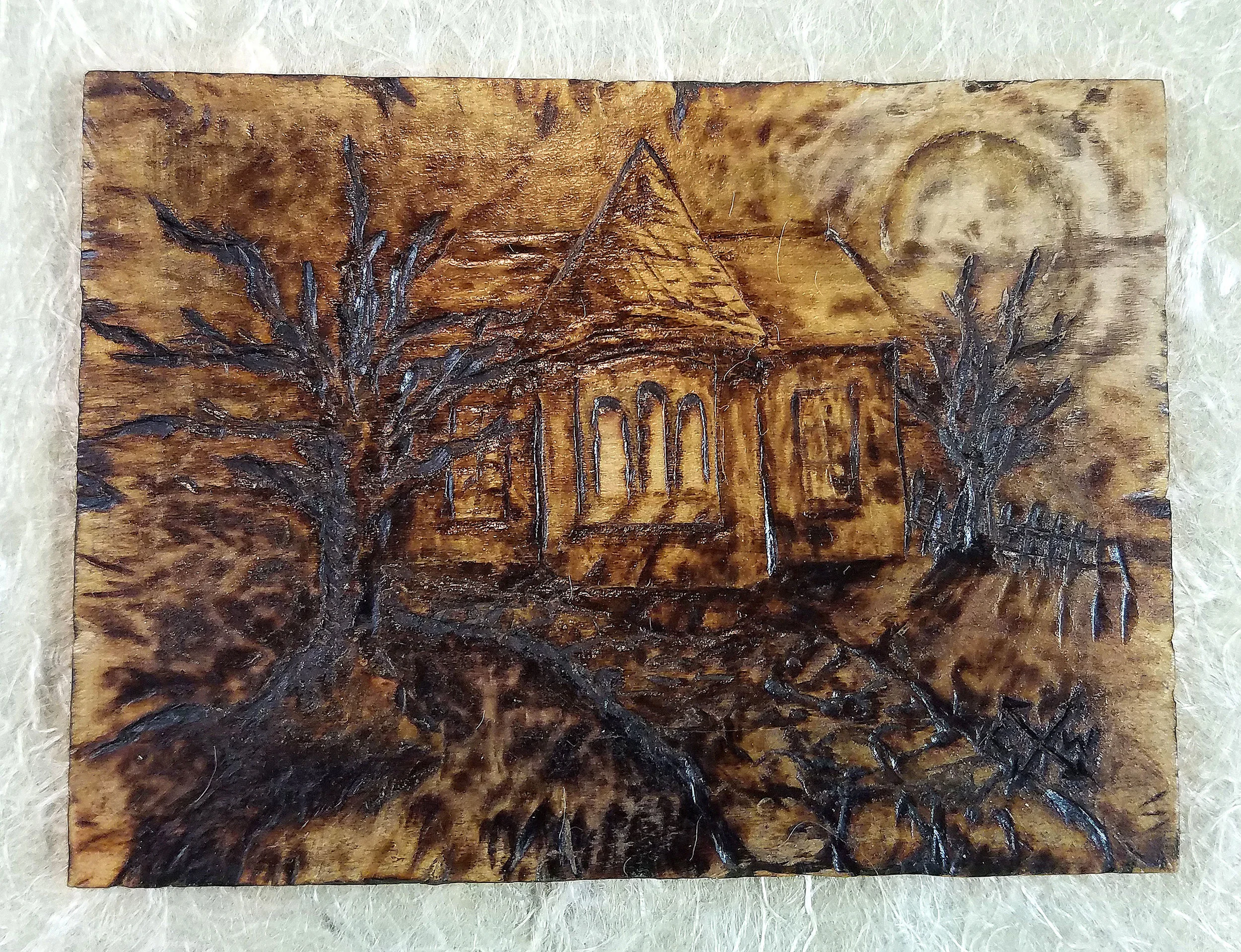 "Thoughts of Home" - pyrography on Poplar plank mounted on handmade paper.