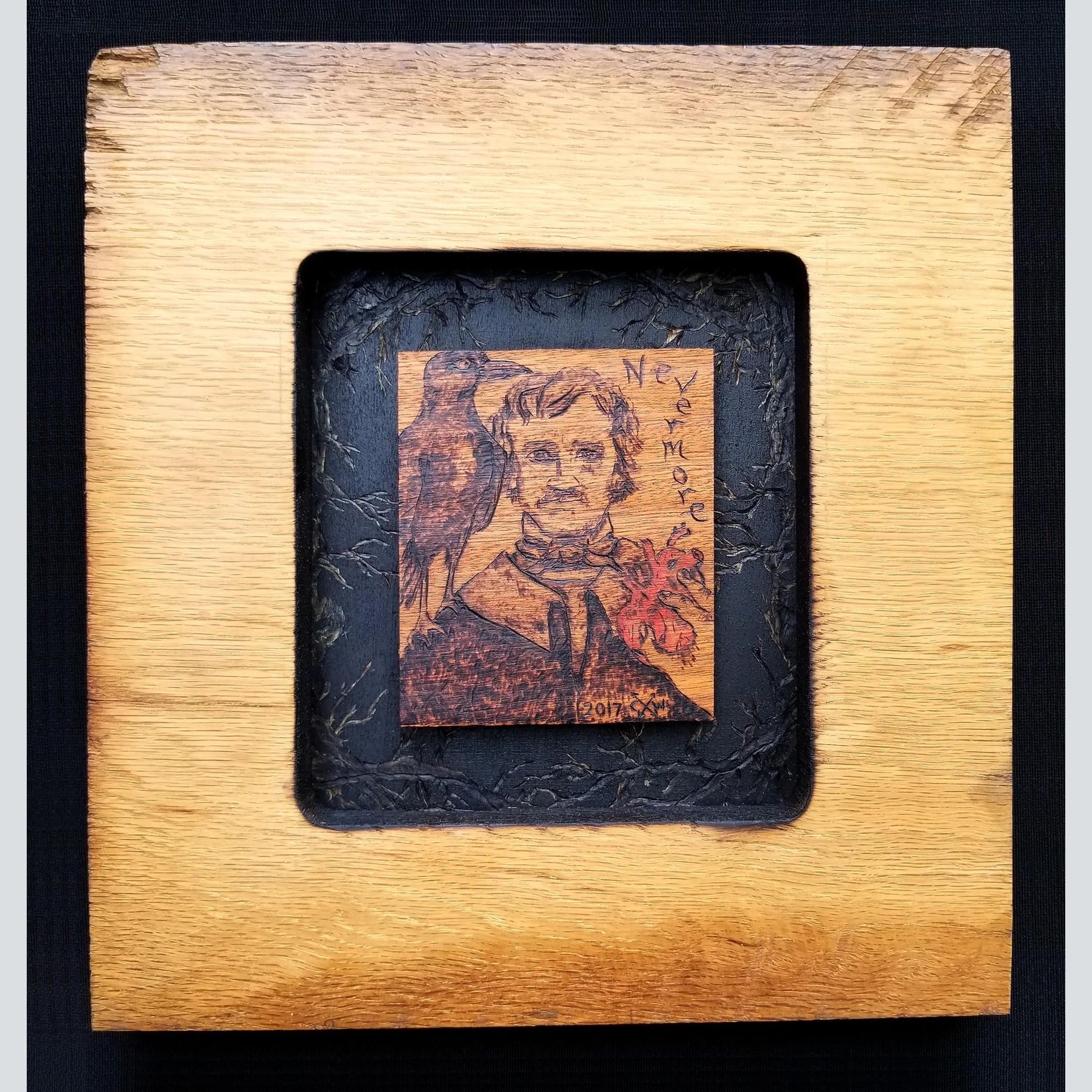 Edgar Allen Poe portrait with raven and a human heart offering in a handmade frame.