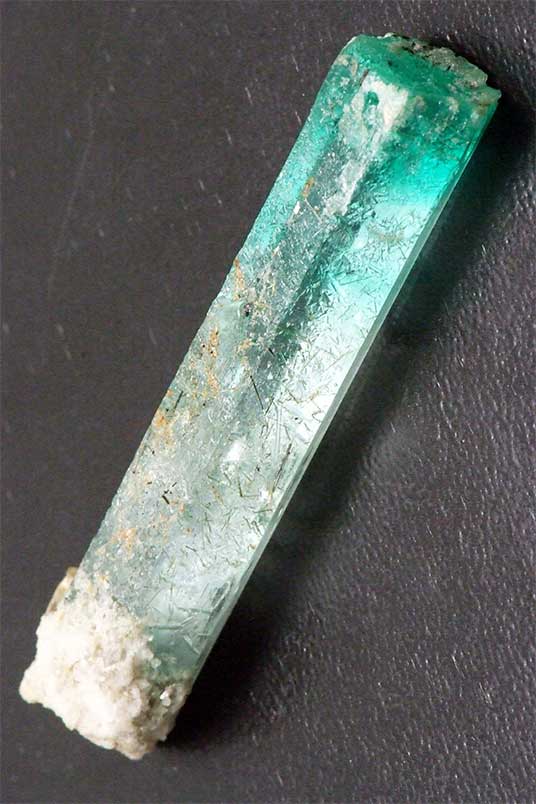 Figure 9. Corroded bi-coloured beryl crystal of 96.57 ct from Skardu Province, Pakistan (see Appendix for aerial view). Total length circa 60 mm. (Photo: K. Scarratt)