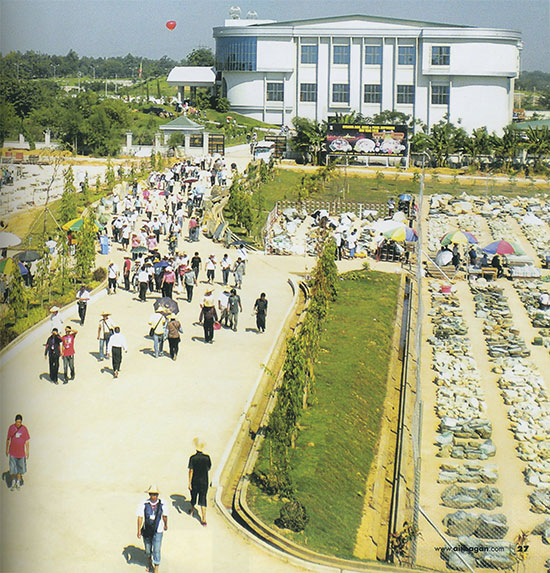 The Gem Museum stands behind outdoor lots of jade at the mid-year gem emporium in 2010
