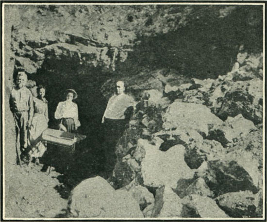 Where topaz and tourmaline are mined. (The writer of the accompanying article is at the tunnel entrance.)