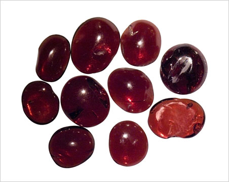 Roughly cabochon-cut garnets recovered from the 1,000-year-old Cirebon wreck. (Photo: Ken Scarratt)