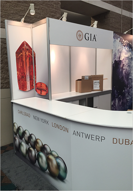 On loan. The GIA booth at AGTA GemFair features images of crystals from the collection of Bill Larson, such as the lovely imperial topaz crystal, above left. (Photo: Bill Larson)