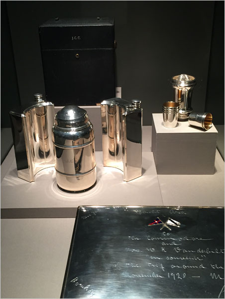 Tippling, schooning and scribbling. Practical items also are included, such as the travel cocktail set above. Space-saving flasks for spirits surround the shaker. At back a citrus reamer with shot glasses. Upended, the reamer attaches to the shaker, making it long-necked, and acting as strainer. The tray is dedicated to William Kissam Vanderbilt II and his second wife, on the occasion of their trip around the world in 1928. (Vanderbilt was an avid yachtsman.) Vanderbilt is addressed in the inscription as "Commodore," a rank he appears to have shared with his great grandfather, Commodore Cornelius Vanderbilt, founder of the family fortune. Below, a pen with its own source of illumination, if not inspiration. (Photos: David Hughes)