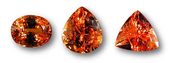 Different levels of clarity are visible here in these spessartite garnets from Nigeria. The oval stone at left is eye clean, i.e., with no clarity defects visible to the unaided eye. In the pear-shaped middle stone, obvious clarity defects are visible, while in the trillion-shaped stone at right, they are even more obvious. (Photos: Wimon Manorotkul)