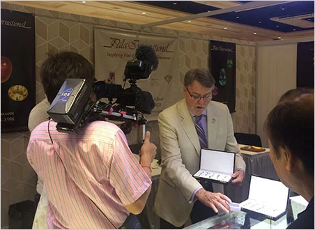 Pala goes international. Bill Larson displays demantoid garnet for the camera of Uruwashi no Houseki Monogatari (Beautiful Story of Gemstones). (Photo: Rika Larson)
