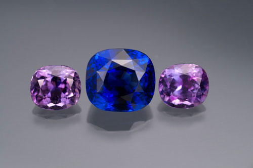 A 7-carat natural Ceylon sapphire flanked by two cuprian tourmalines