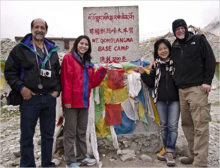 Dana Schorr, Billie Hughes, Wimon Manorotkul and Richard Hughes stand at the base camp of Mt. Everest (Mt. Qomolangma) in the mid-summer of 2011 at 17,000 feet. (Photo courtesy Richard W. Hughes, from this article)