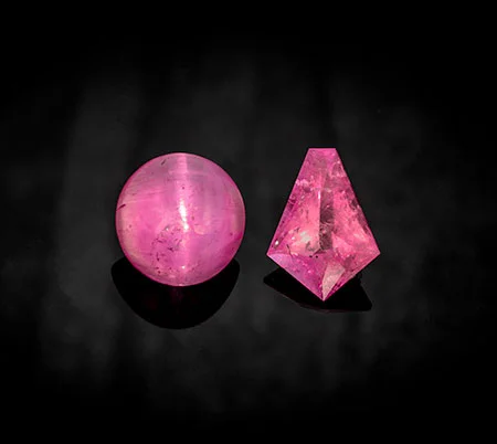 Pezzottaites from Madagascar: An 8.20-carat cabochon cat's eye measuring 12.8 x 12.5 mm and a 4.80-carat kite shape measuring 14.7 x 10.4 mm. Both are new to Pala's inventory. (Photo: Mia Dixon)