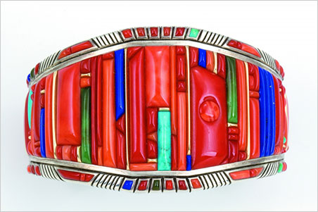 Bracelet. Raymond C. Yazzie, 2005. Silver inlaid with coral, turquoise, lapis lazuli, 14-karat gold accents. 2 3/8 x 1 in. Collection of Mark and Martha Alexander. (Photo: Michael S. Waddell)