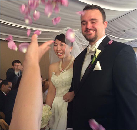 Bride and Groom. Rika and Will are pelted with petals as they exit the wedding tent. (Photo: Keiko Hayakawa)