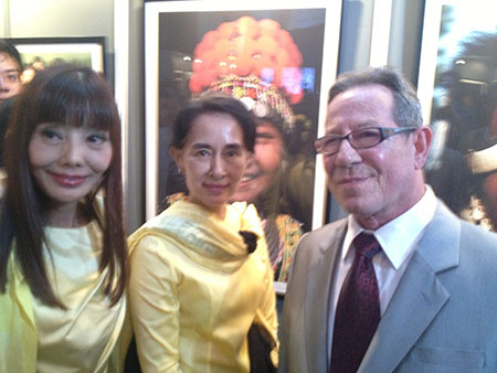 " The Vanishing Tribes of Burma ," an exhibition of photographs by Richard K. Diran, has found a permanent home in Yangon’s National Museum, according to Mizzima News, October 12. Diran is a longtime friend of Pala International's Bill Larson, who snapped this photo of Daw Aung San Suu Kyi after meeting her at the reception for Diran, right, a year ago. (Photo: Bill Larson)