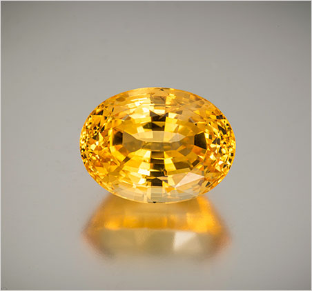 Natural yellow sapphire from Sri Lanka, 27.27 ct, 18.88 x 14.11 x 11.83 mm. It comes with an AGL brief. Inventory #19961 . (Photo: Mia Dixon)