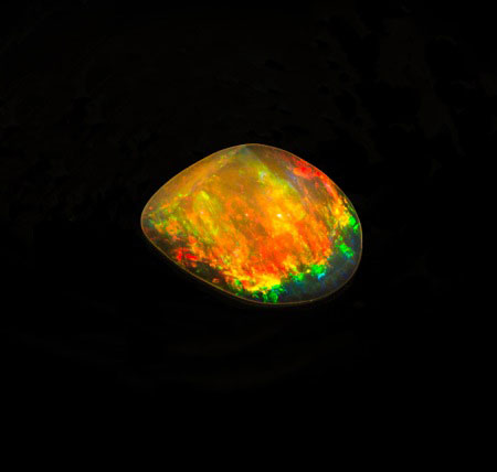 Earth wind and fire. Fire opal from Mexico carved by master lapidary Steve Walters. It measures 29.5 x 20.5 x 12.4 mm and weighs 29.65 ct. Pala Inventory #20393 . (Photo: Mia Dixon)