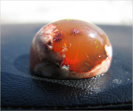 Matrix opal containing goethite needles.