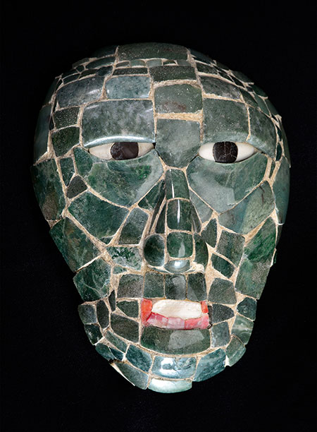 This mask was found in the tomb of Great Scrolled Skull, a ruler of Santa Rita Corozal in Belize during the Early Classic period (250–900 C.E.). A symbol of power, Great Scrolled Skull probably wore it as an ornament on his belt or on a necklace. The mask's jade, shell, and obsidian were attached to an organic backing that had decomposed, so when it was found, it was a pile of chips that had to be reconstructed. For more on Maya jadeite, see this profile of work by George E. Harlow, curator of the American Museum of Natural History. (Image courtesy of the National Institute of Culture and History and Science Museum of Minnesota)