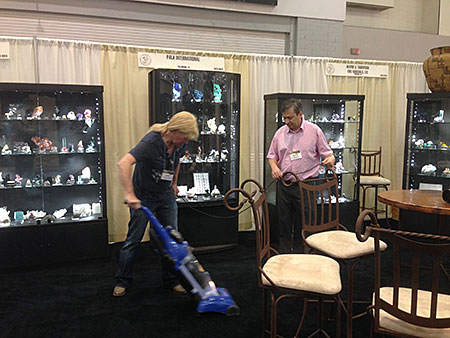 You missed a spot. Pala boothmates Wayne A. Thompson (of Ikons fame) and Alain Martaud tidy up the place a bit. It's a dirty job, but someone has to do it—and to supervise—and document. (Photo: Will Larson)
