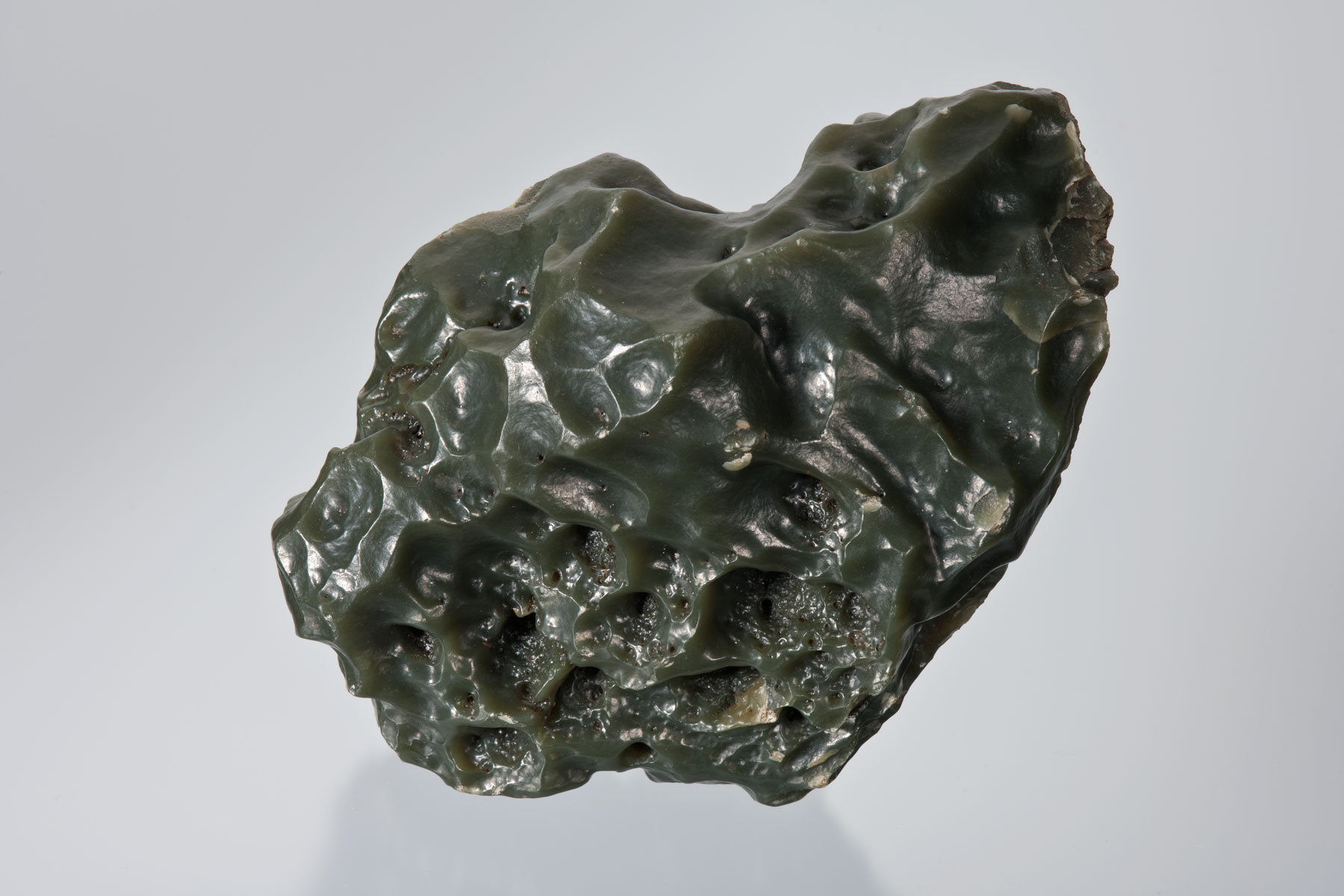 Above is shown a very nice 3-lb naturally wind-polished cinder slick olive jade. The natural polish on this specimen shows the work of the intensive high sand winds of the Wyoming plains. (Photo: Robert Weldon)
