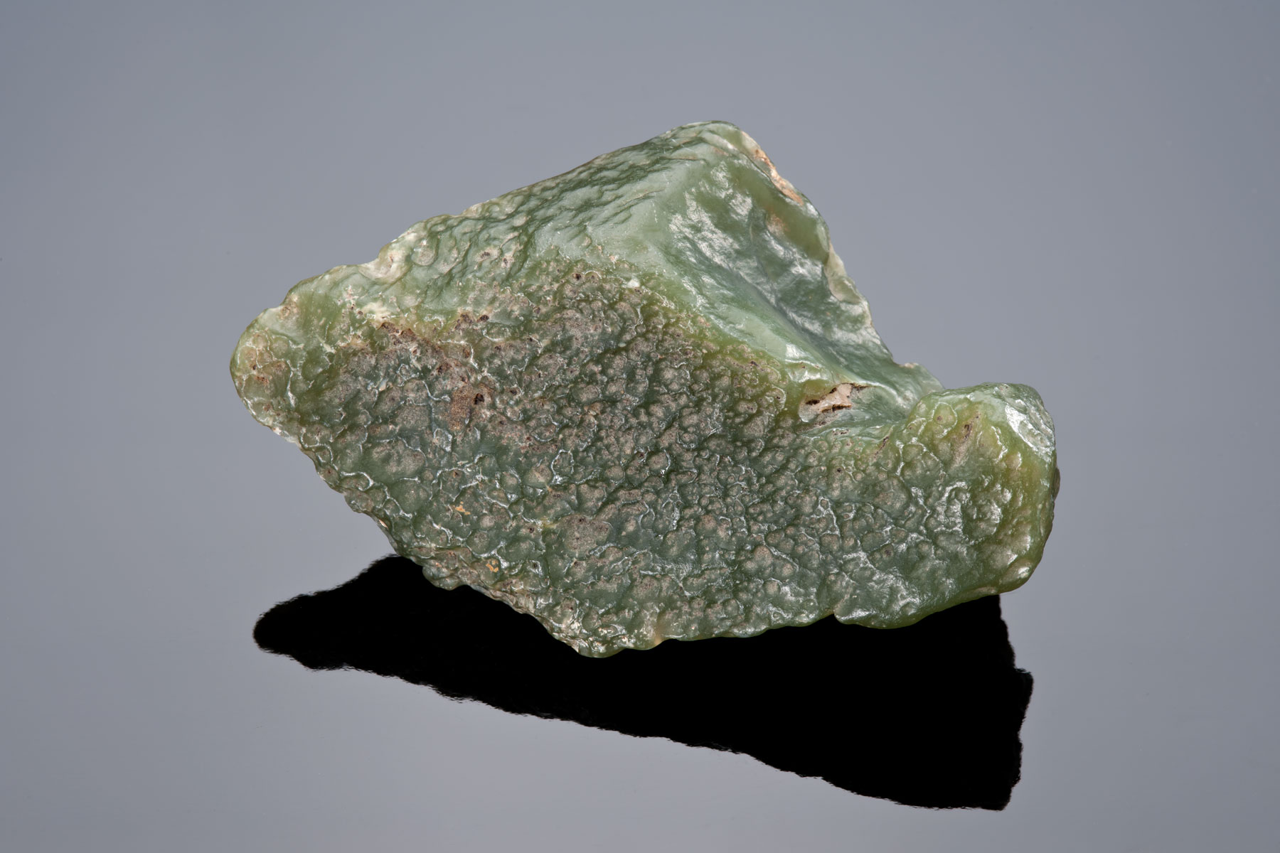 This delicate light olive nephrite slick is one that is desired by both collectors and carvers. The translucency is easy to see in this photo.
