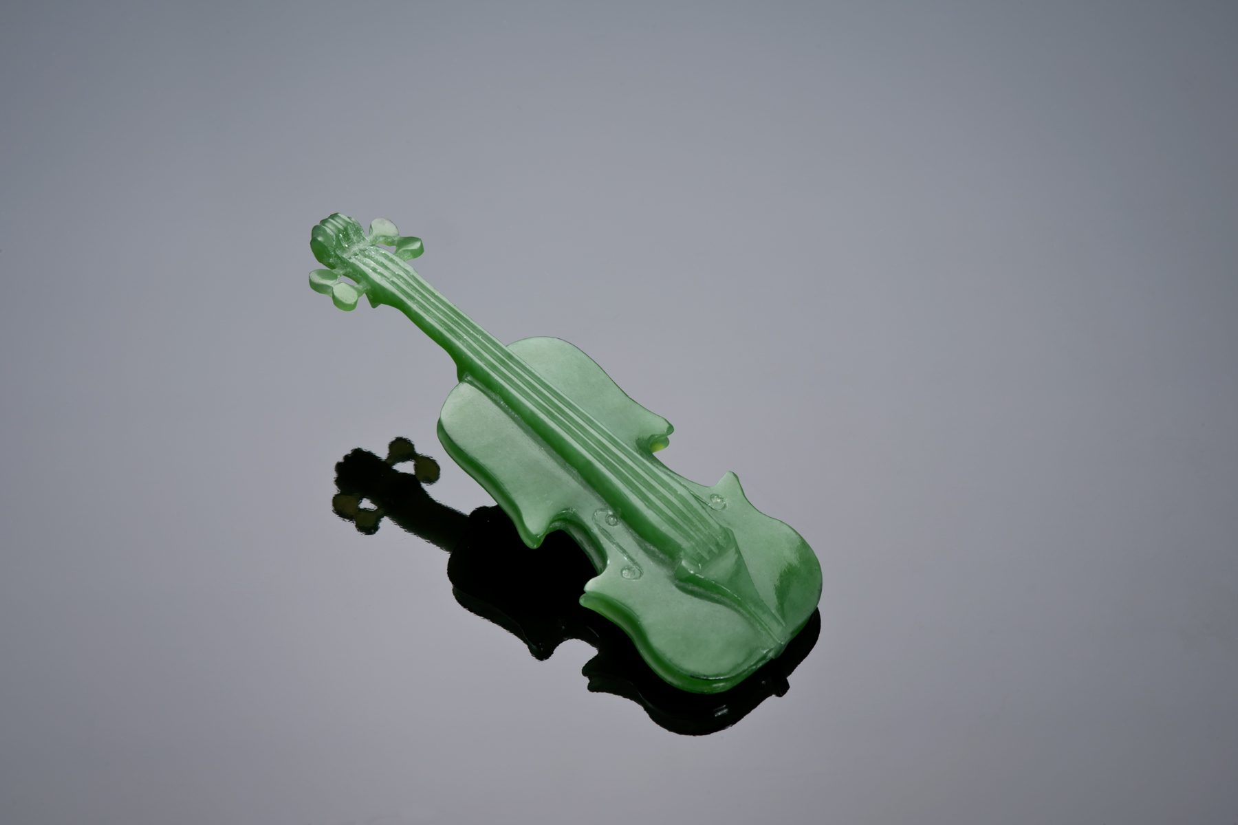 Dale Blankenship carved this apple green Wyoming jade violin from a slice given to him by Pansy Kraus (former Lapidary Journal editor). He was able to carve two violins, one he gave to Pansy and the other he gave to me. (Photo: Robert Weldon)