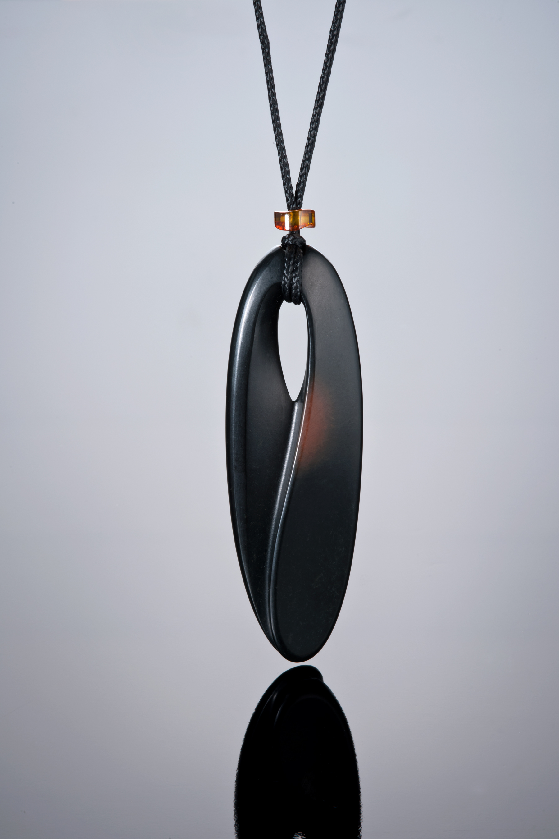 Above is a 3-inch pendant carved by Peter Schilling from Edward's black jade with some of the rind shown. (Photo: Robert Weldon)