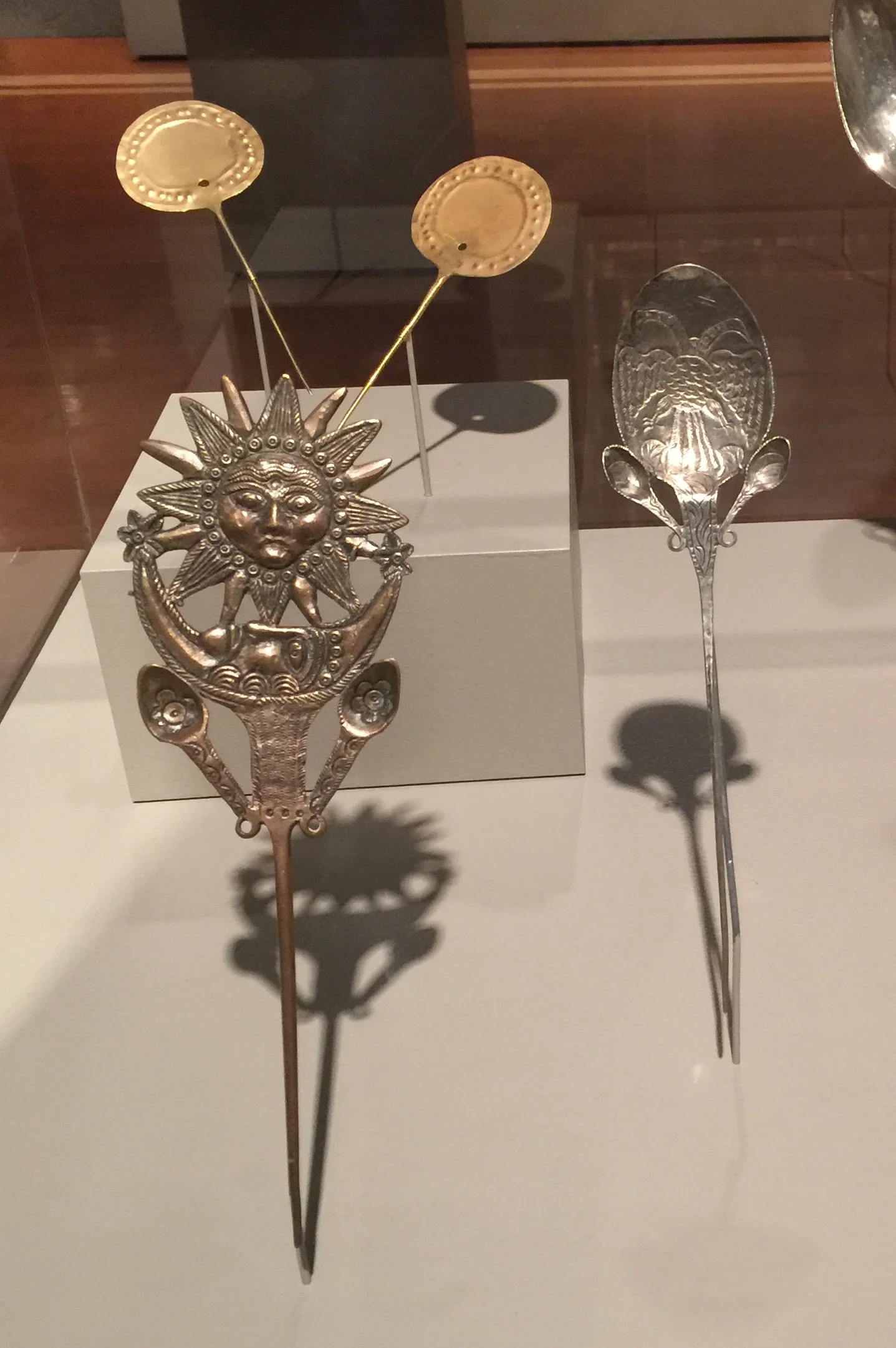 Upper left, pair of tupu pins, Inca, Peru, Chile or Bolivia, 1400–1500, gold. Anonymous gift, 1995.318.1 & 2. Lower left, ttipqui pin, Peru, 1800s, silver-plated copper. Gift of Mrs. LeRoy Schwartz, 1954.156. Right, ttipqui pin, Peru, 1800s, silver. Gift of Dr. Mary Lanius, 2008.844. (Photo: David Hughes)