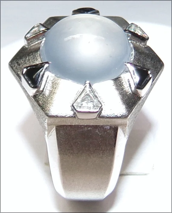 Black and white. This ring, designed by Michael Jakubowski, features a center stone of Burmese ice jade, accented by small stones set in its six prongs. (Photo: Michael Jakubowski)