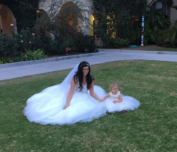 The newly married Alison Larson (kinda has a, er, ring to it) shares a moment with flower girl Sierra. (Photo: Carl Larson)