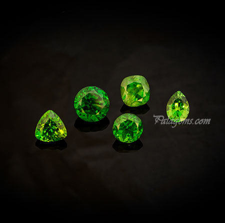 Russian Quintet. Demantoid garnets from the Kladovka mine in the Ural Mountains. These stunning stones were mined in 2004 but only recently cut by master Marty Key. The 2.57-carat round is the finest green of this material's production. (Photo: Mia Dixon)