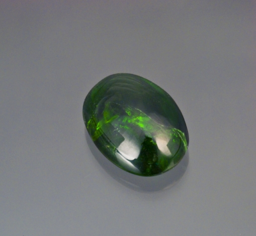 21.22 cts. deep chrome green diopside cabochon from Tanzania. (Photo: Mia Dixon)