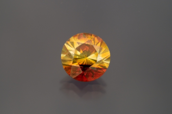 Greenish-yellow with an orange corner, cut in France with lots of sparks. A fun "funky" stone. (Photo: Mia Dixon)