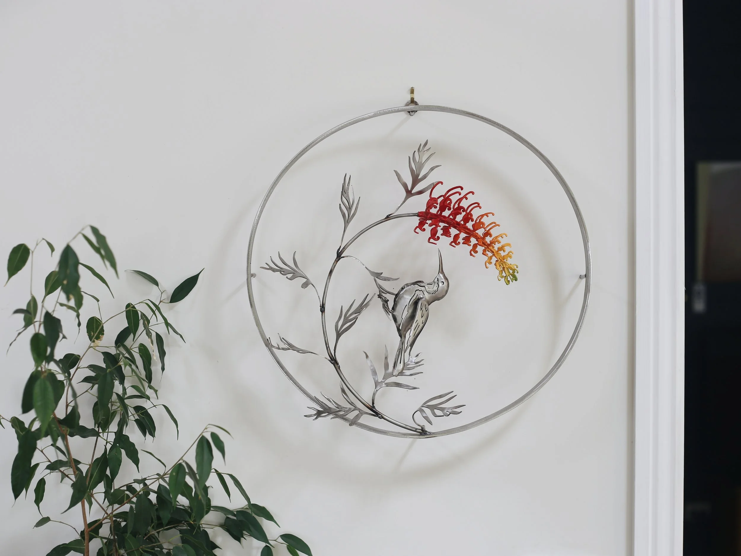 Small Grevillea wall sculpture in stainless with Eastern Spinebill. By Grat Flather